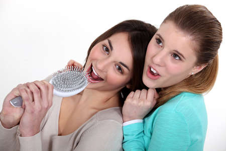 Teen with hairbrush singingの写真素材