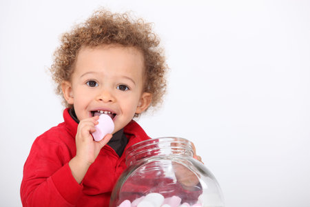 A cute kid eating marshmallowの写真素材