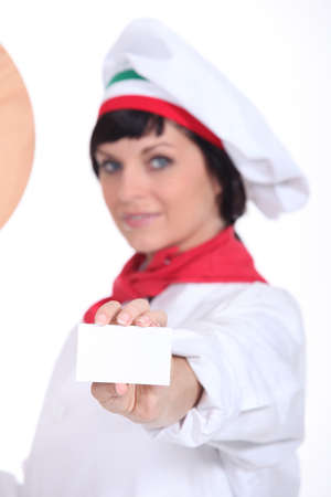 Pizza chef holding up a blank businesscardの写真素材