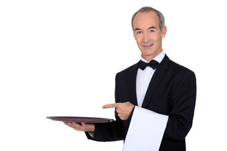 Waiter pointing to a trayの写真素材