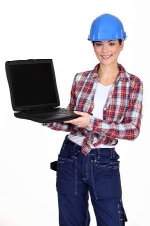Female manual worker showing off laptopの写真素材