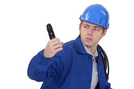 Unfriendly tradesman holding up a pair of wire clippers