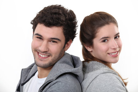 Portrait of a young man and woman standing back to back
