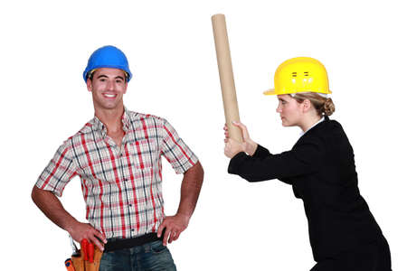 Engineer hitting a construction worker over the headの写真素材