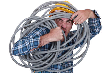 Man tangled in cableの写真素材