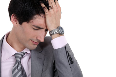 A portrait of a businessman having a headache 