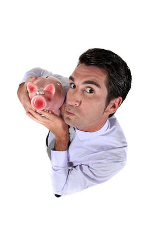 Man holding a piggy bankの写真素材