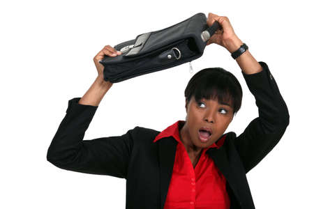 Woman protecting her head with a suitcaseの写真素材