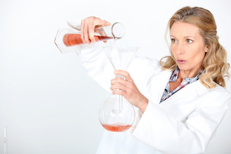 Scientist carefully mixing chemicals