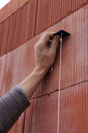 Mason checking wall is straightの写真素材