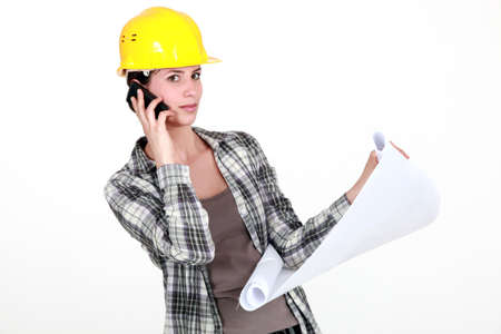 A foreman on the phone going over the plans の写真素材