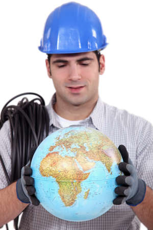 Artisan looking at globeの写真素材