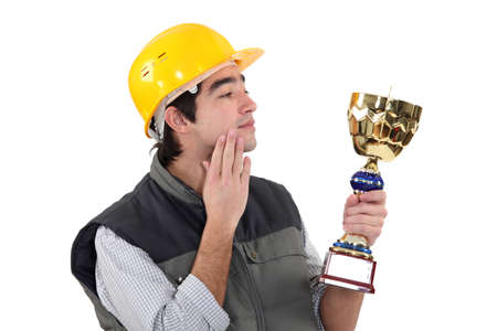 Construction worker with a trophyの写真素材