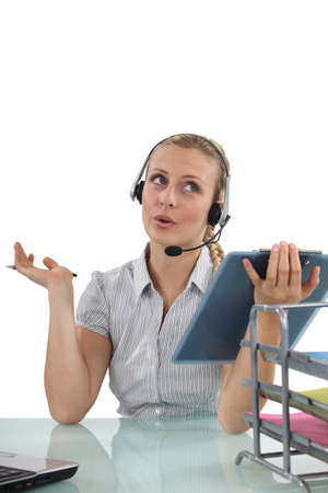 Blond receptionist with clip-boardの写真素材