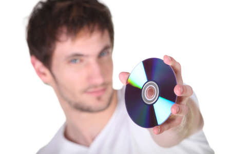 Young man showing CD, studio shotの写真素材