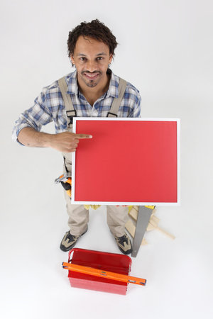 Carpenter pointing at red panel