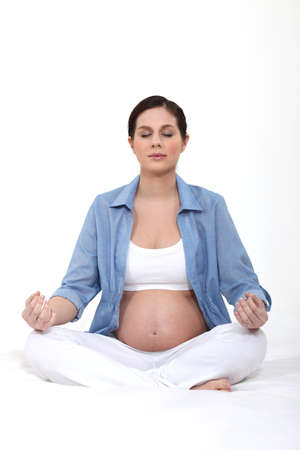 Pregnant woman in a yoga positionの写真素材
