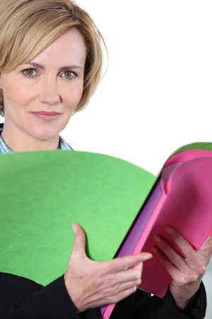 Woman holding brightly colored files