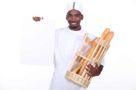 Baker with a basket of baguettes and a board left blank for your message