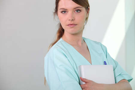 Medical assistant holding a patient fileの写真素材