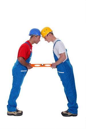 two craftsmen holding a levelの写真素材