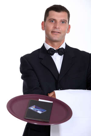 Waiter with the bill and a credit cardの写真素材