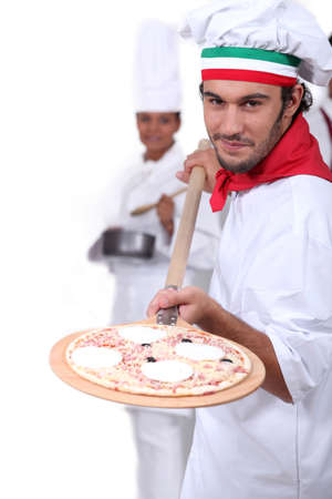 Pizza maker displaying his pizzaの写真素材