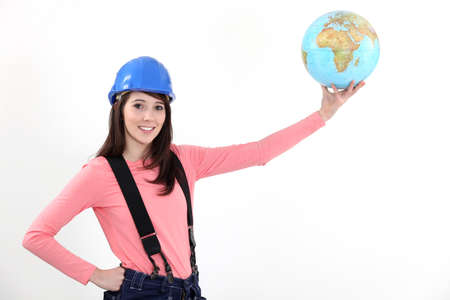 Female manual worker holding globeの写真素材