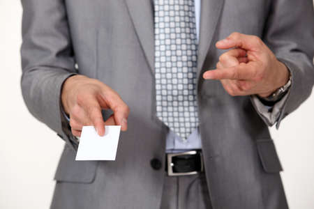 Man pointing at business cardの写真素材
