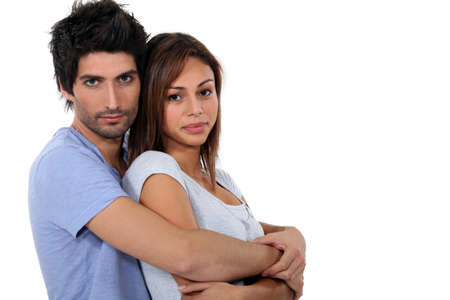 Couple hugging, studio shotの写真素材