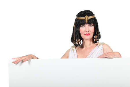 Woman in Cleopatra costume with blank board ready for textの写真素材