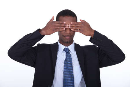 Black man covering his eyesの写真素材