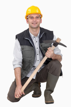 Man crouching with pick-ax