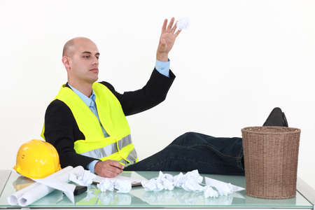 An architect throwing drafts in the garbage cans の写真素材