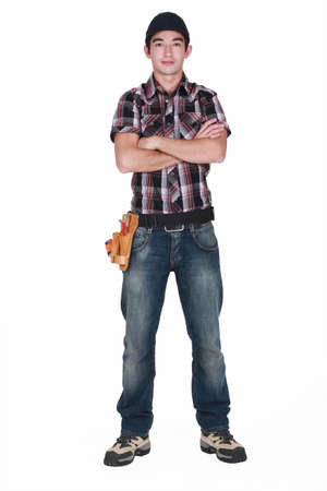 Young builder stood with arms foldedの写真素材