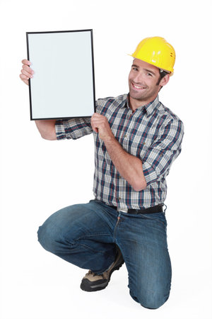 Manual worker holding a blank poster 