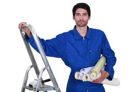 Decorator with step-ladder about to hang wallpaperの写真素材