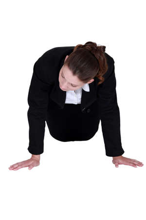 Businesswoman doing knee push-upsの写真素材