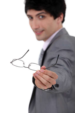 A businessman handing over his glasses の写真素材
