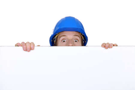 craftsman hiding behind copyspaceの写真素材