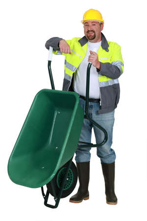Workman with a wheelbarrowの写真素材