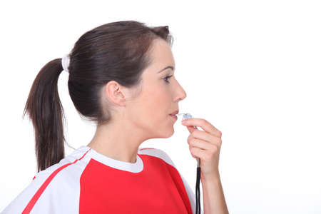 Woman blowing a whistleの写真素材