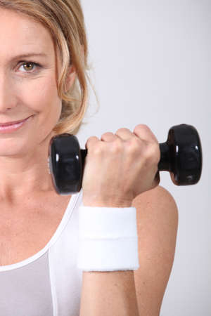 Closeup of woman with dumbbellの写真素材