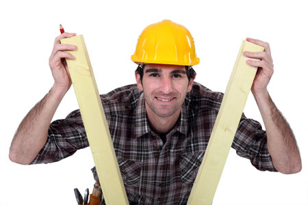 Man between two planks of wood