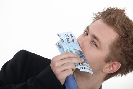 Successful business man smelling money