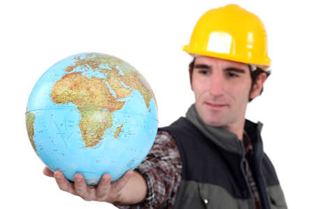 Tradesman holding a globeの写真素材
