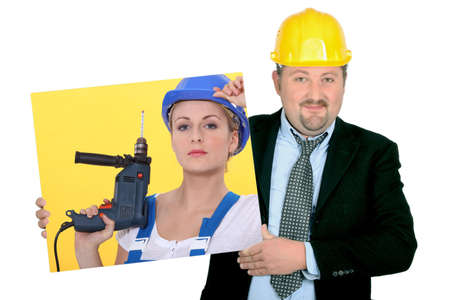Contractor holding picture of woman building workerの写真素材