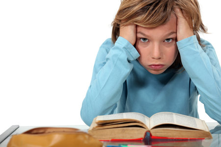 Boy exasperated with his homework