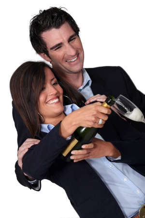 Happy couple pouring champagneの写真素材