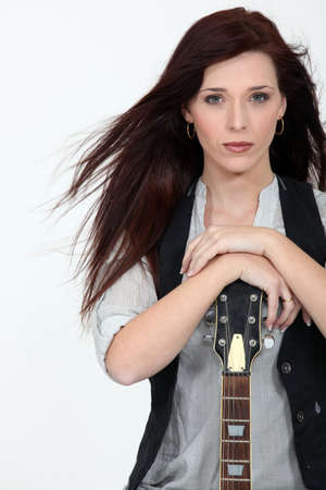 Cool woman with a guitarの写真素材